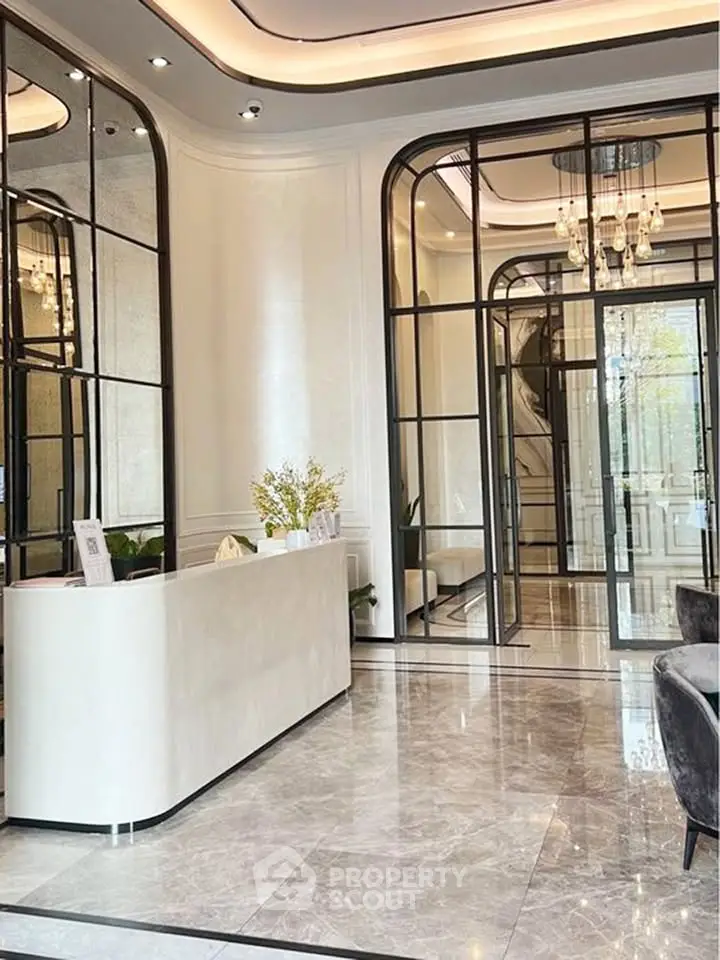 Luxurious modern lobby with elegant marble flooring and stylish glass partitions.
