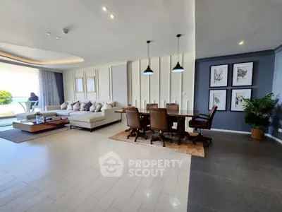 Luxurious open-plan living and dining area with modern decor and large windows.