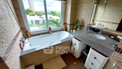 Luxurious bathroom with large bathtub and scenic window view