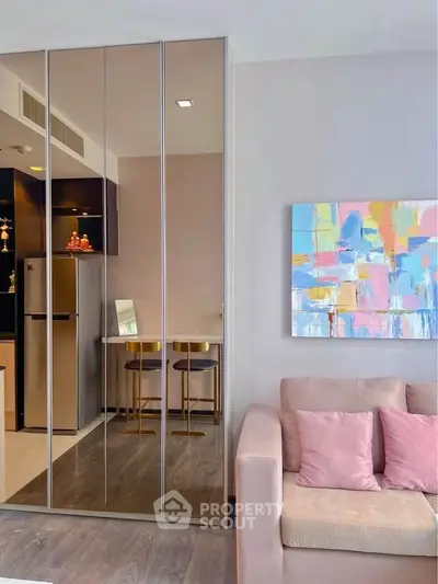 Modern living room with mirrored closet and abstract art