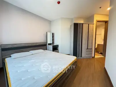 Spacious bedroom with modern furniture and ensuite bathroom in a stylish apartment.