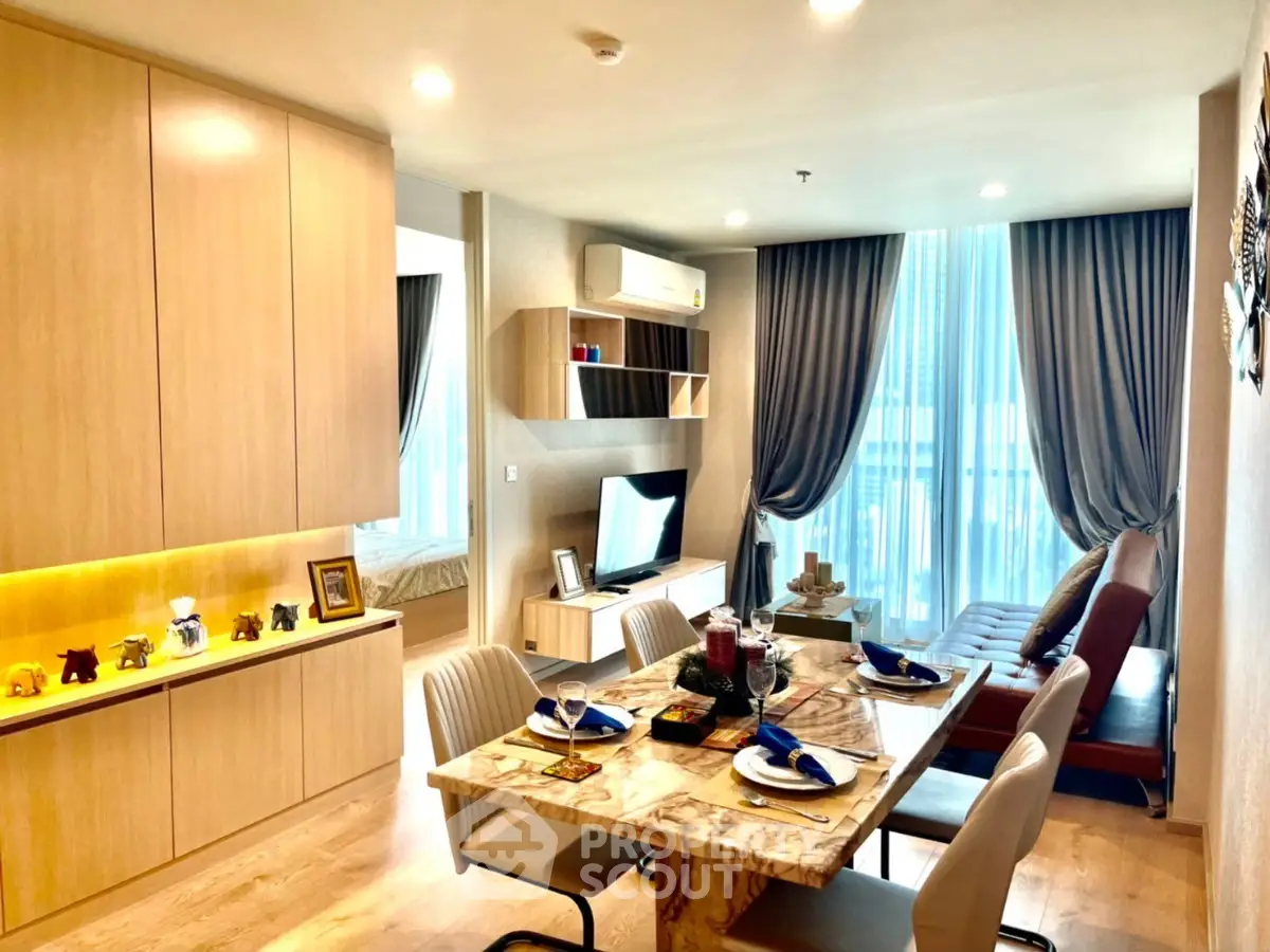 Modern living room with dining area, stylish decor, and natural light in a contemporary apartment.