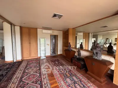 Spacious living room with elegant wooden flooring and decorative accents