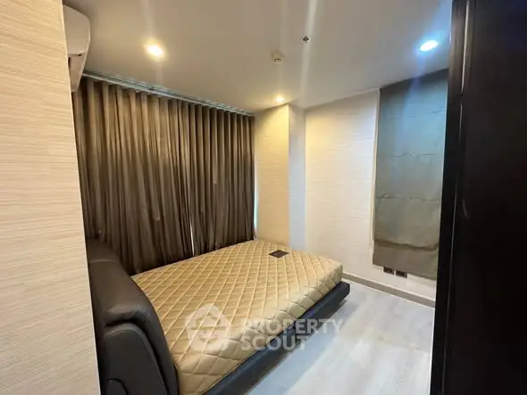 Modern bedroom with sleek design and cozy ambiance, featuring a comfortable bed and stylish curtains.
