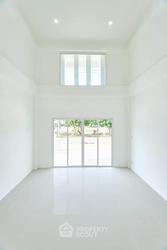 Spacious modern living room with high ceilings and large windows