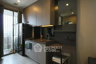 Modern compact kitchen with sleek cabinetry and balcony view