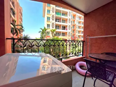 Charming balcony with outdoor seating and scenic view of colorful apartment complex.