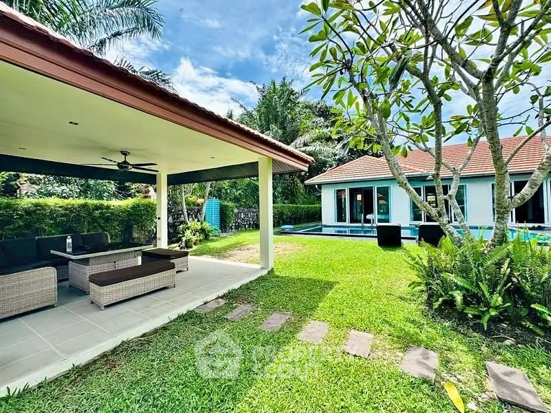 Stunning tropical villa with lush garden and poolside lounge area