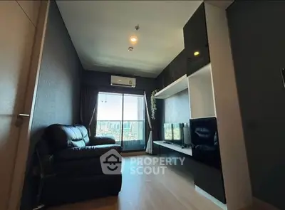 Modern living room with sleek design and city view from window.