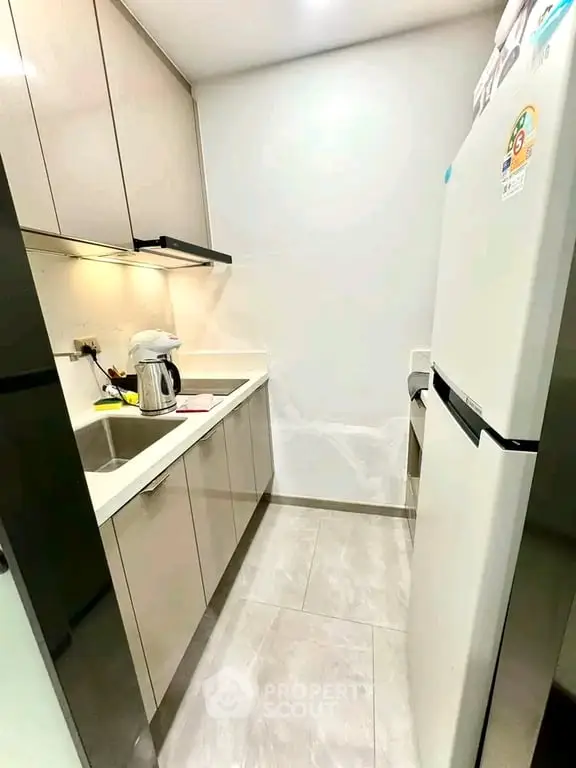 Modern compact kitchen with sleek cabinetry and stainless steel appliances