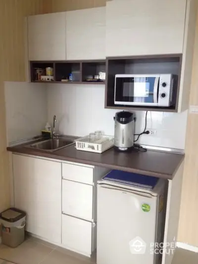 Compact kitchen with modern appliances and sleek cabinetry