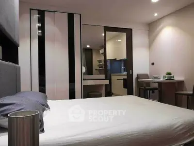 Modern bedroom with sleek design and integrated kitchen area, perfect for urban living.