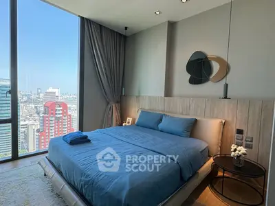Luxurious bedroom with stunning city view and modern decor in high-rise apartment.