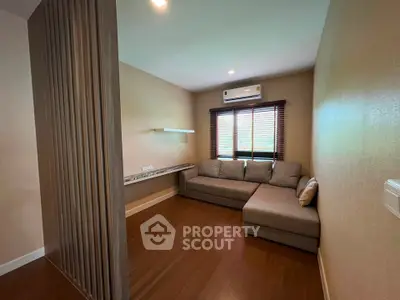 Modern living room with wooden flooring and cozy sectional sofa