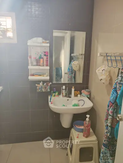 Cozy bathroom with modern sink and ample storage space.
