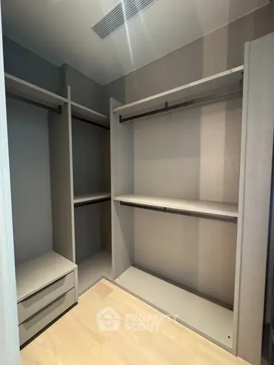 Spacious walk-in closet with modern shelving and storage solutions.