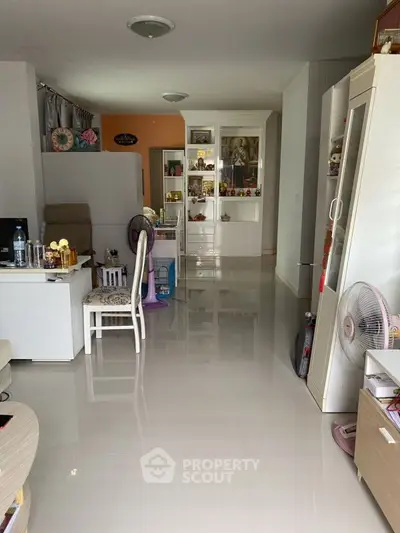 Spacious living area with modern decor and glossy flooring