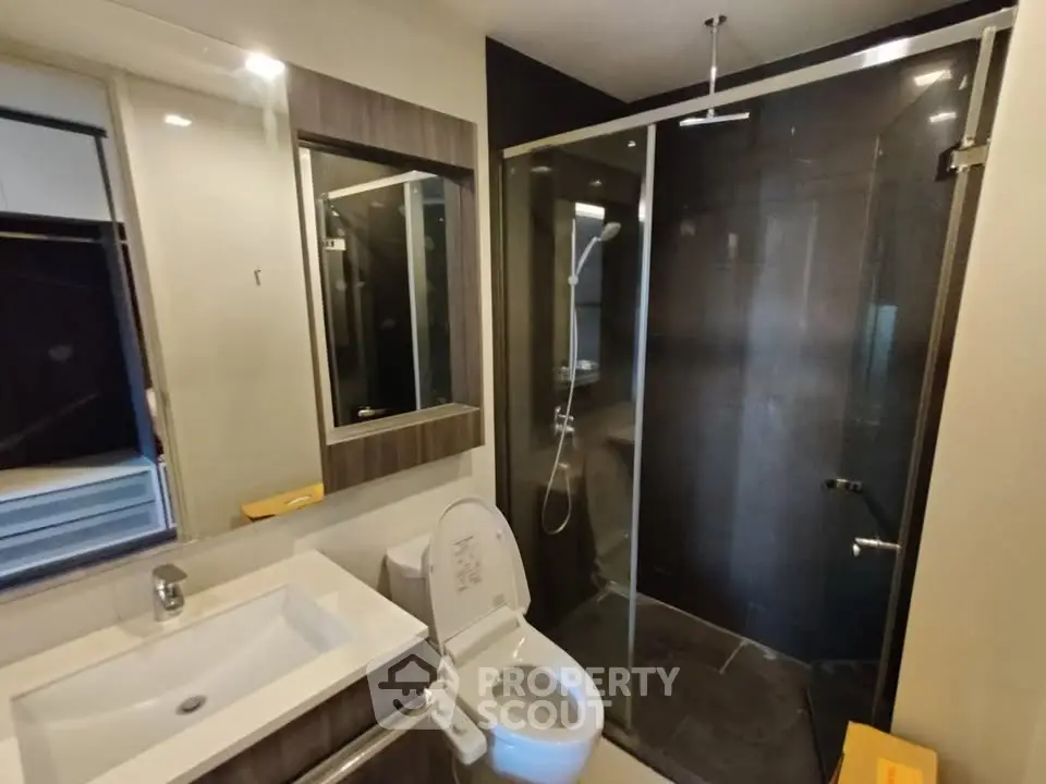 Modern bathroom with glass shower and sleek fixtures
