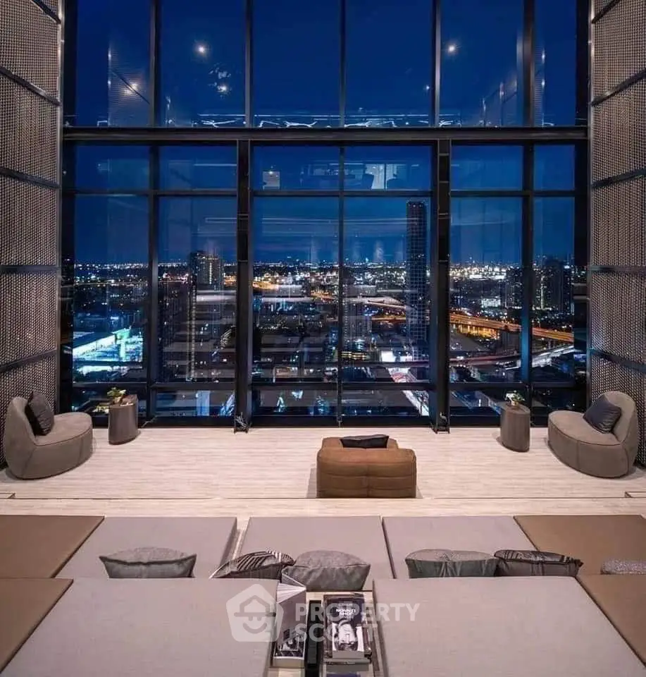 Luxurious high-rise living room with stunning city skyline view at night.