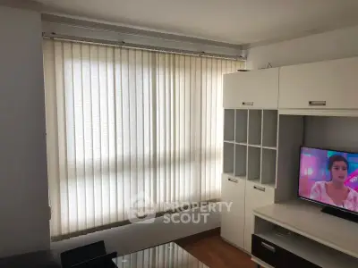 Modern living room with large window and stylish entertainment unit