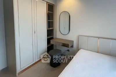 Modern bedroom with sleek wardrobe and stylish mirror