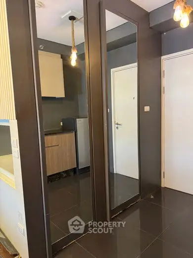 Modern apartment interior with sleek kitchen and large mirrors