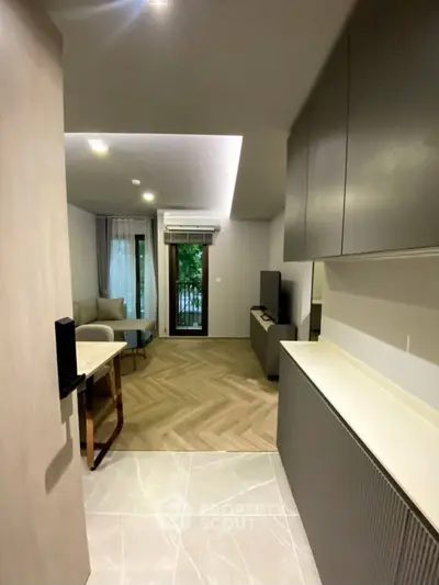 Modern living room with sleek design and natural light, featuring a cozy seating area and stylish flooring.