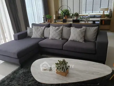 Modern living room with stylish gray sofa and elegant decor