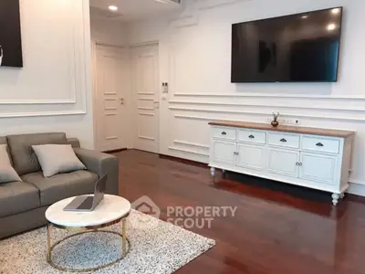 Elegant living room with modern decor and wall-mounted TV