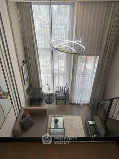 Luxurious high-ceiling living room with modern decor and city view.