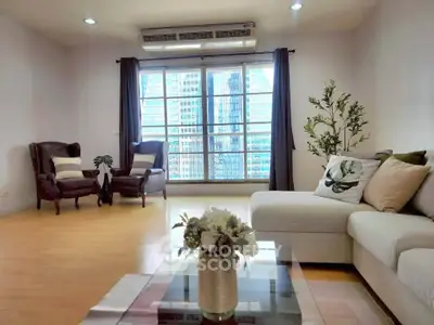 Spacious living room with modern furniture and city view, perfect for urban living.