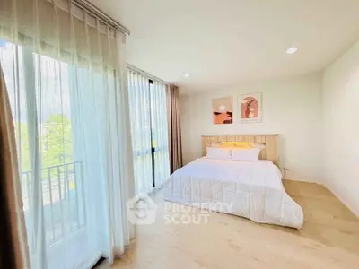 Bright and airy bedroom with large windows and stylish decor