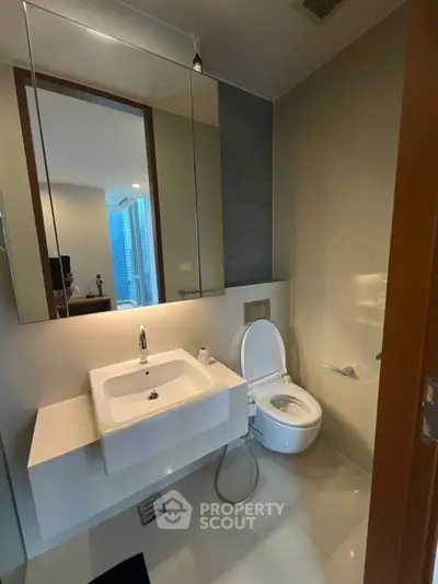 Modern bathroom with sleek fixtures and city view from window, perfect for urban living.