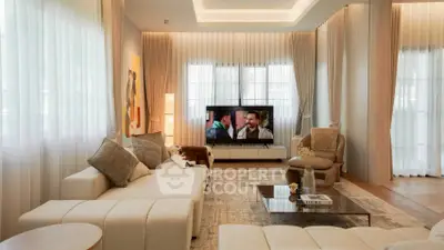 Luxurious living room with modern decor and large windows, perfect for relaxation and entertainment.
