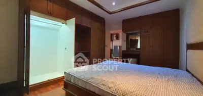Spacious bedroom with built-in wardrobe and cozy lighting