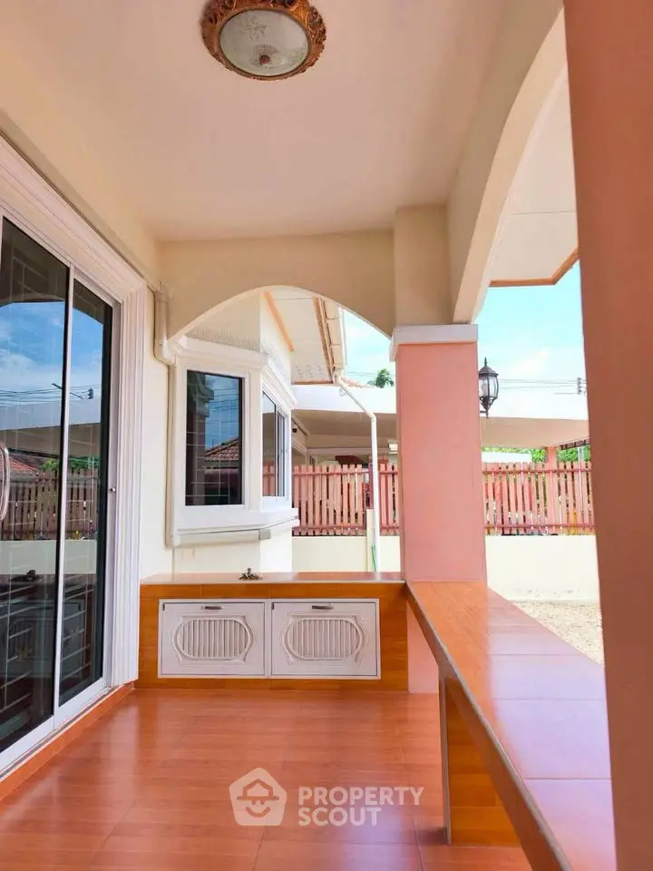 Charming home entrance with wooden flooring and large windows