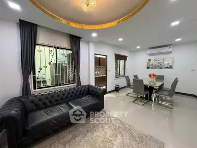 Elegant living room with luxurious leather sofa and modern dining area, perfect for stylish urban living.