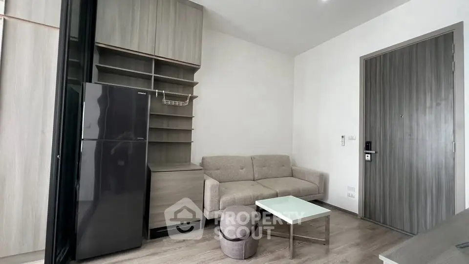 Modern living room with sleek furniture and built-in storage in a cozy apartment.
