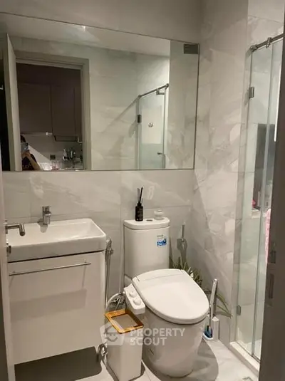 Modern bathroom with sleek fixtures and glass shower enclosure