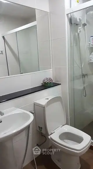 Modern bathroom with sleek fixtures and glass shower enclosure