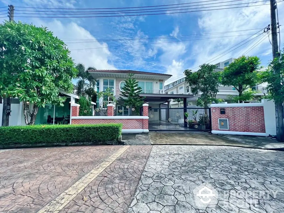 Stunning two-story house with lush garden and spacious driveway in a serene neighborhood.