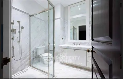 Luxurious marble bathroom with glass shower and elegant vanity