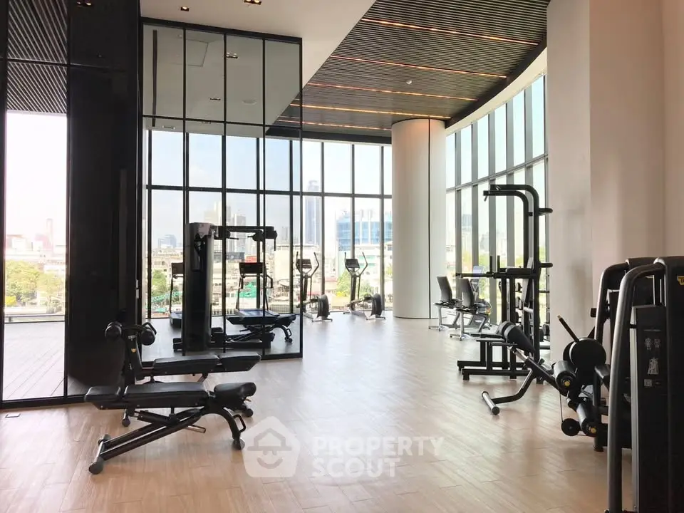 Modern gym with panoramic city views and state-of-the-art fitness equipment.