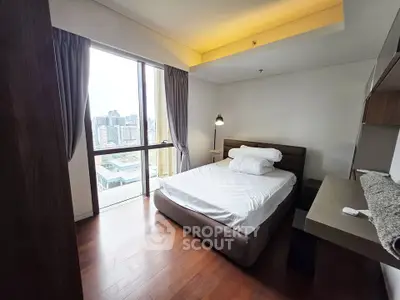 Modern bedroom with city view and stylish decor in urban apartment