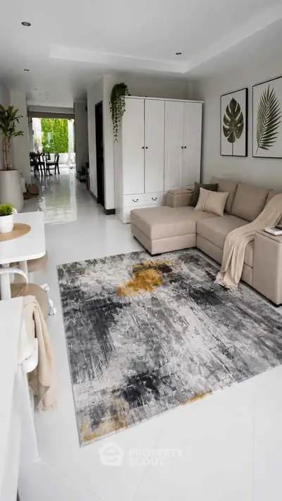 Modern living room with stylish decor and spacious layout, featuring a cozy sectional sofa and artistic rug.