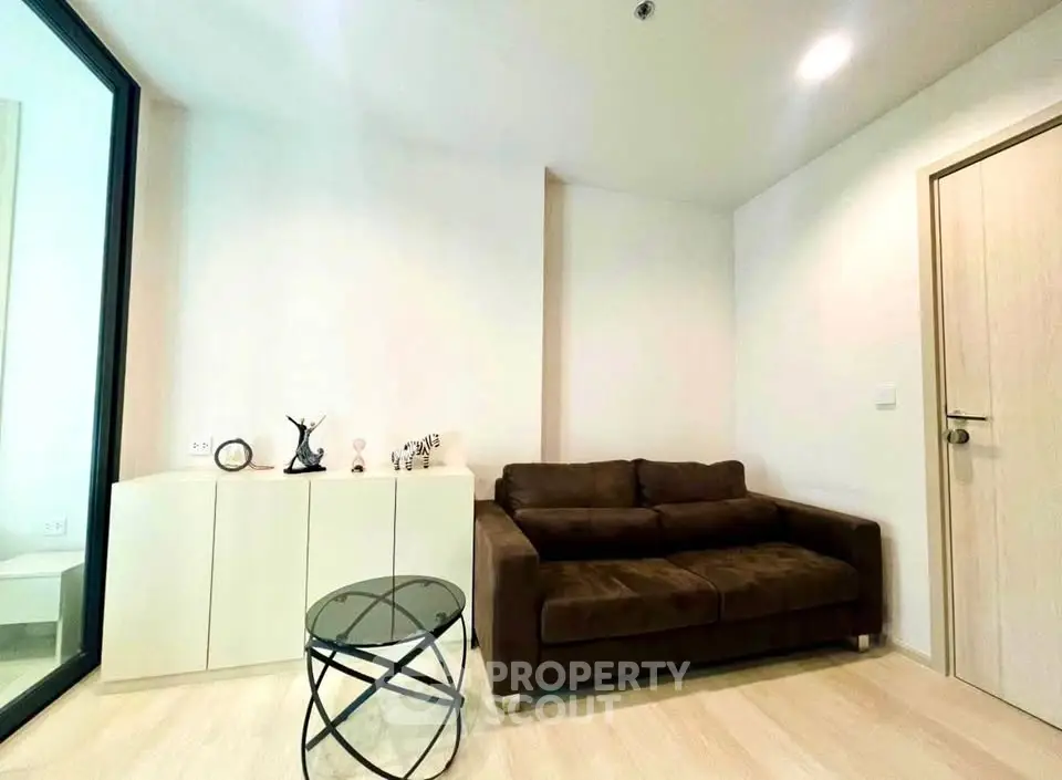Modern living room with brown sofa and stylish decor in a cozy apartment.