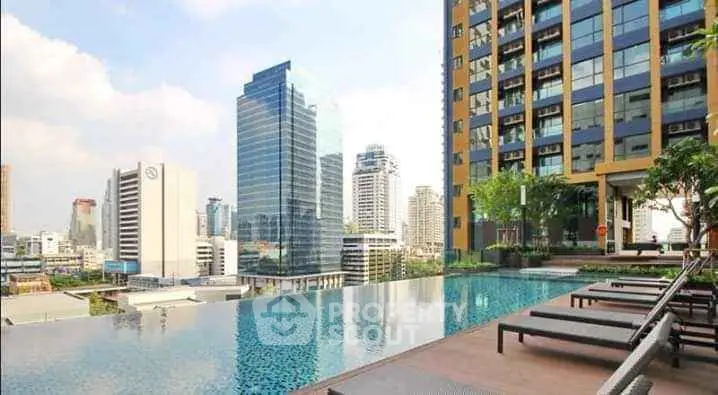 Luxurious rooftop pool with stunning city skyline view in modern high-rise building.