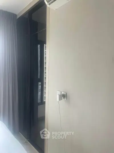 Modern bedroom with large window and sleek design