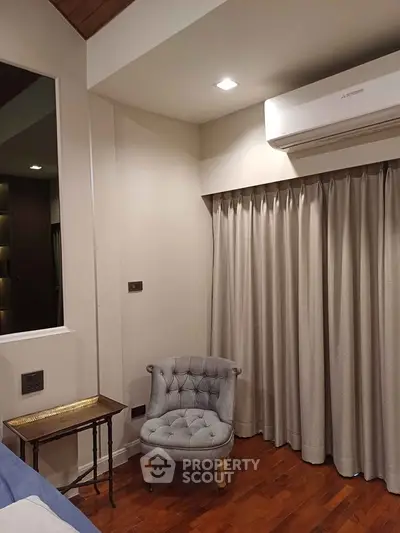 Cozy corner in a modern bedroom with elegant chair and air conditioning