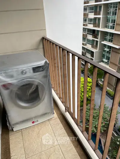 Modern balcony with washing machine and city view, perfect for urban living convenience.